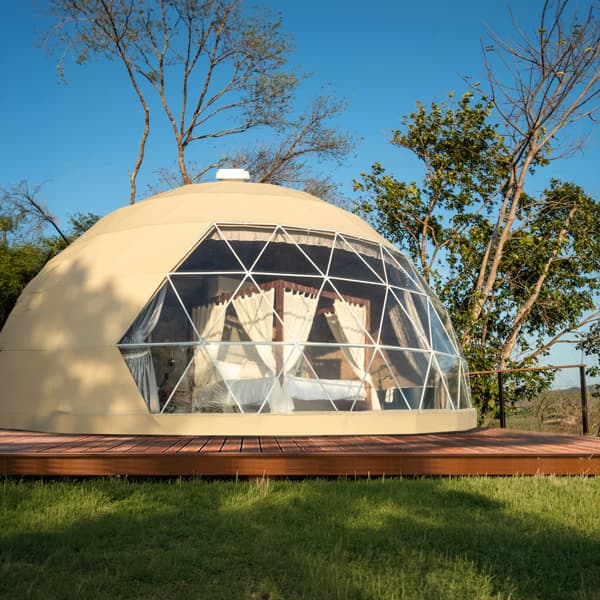 Beige exterior cover installed on a Luna geodesic dome