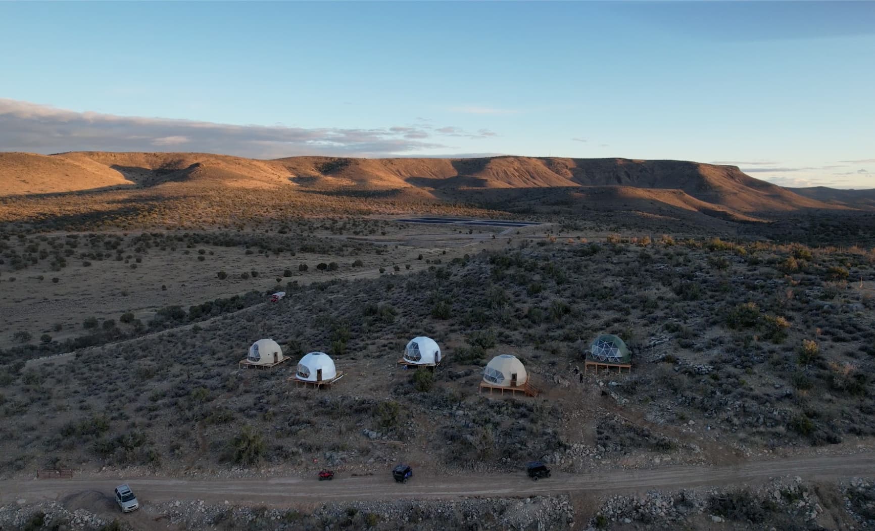 A group of Luna domes on a dry, open landscape