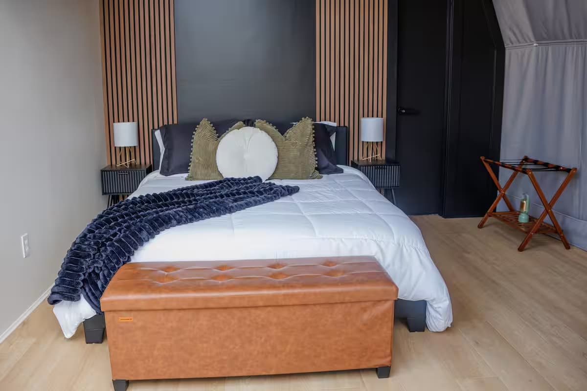 Bed looking toward the panoramic window of a dome