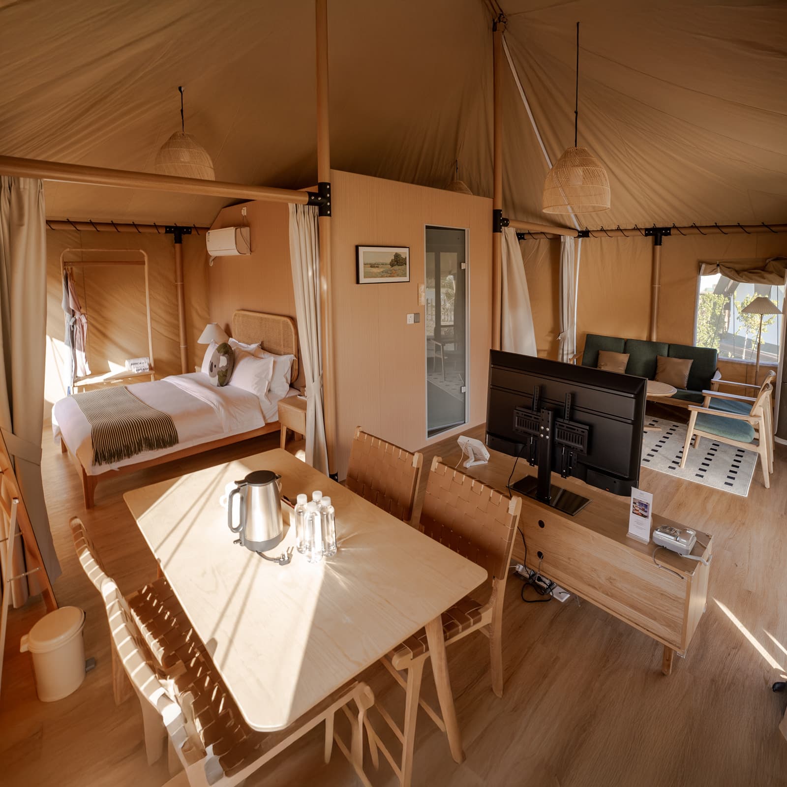 Safari tent surrounded by green landscape