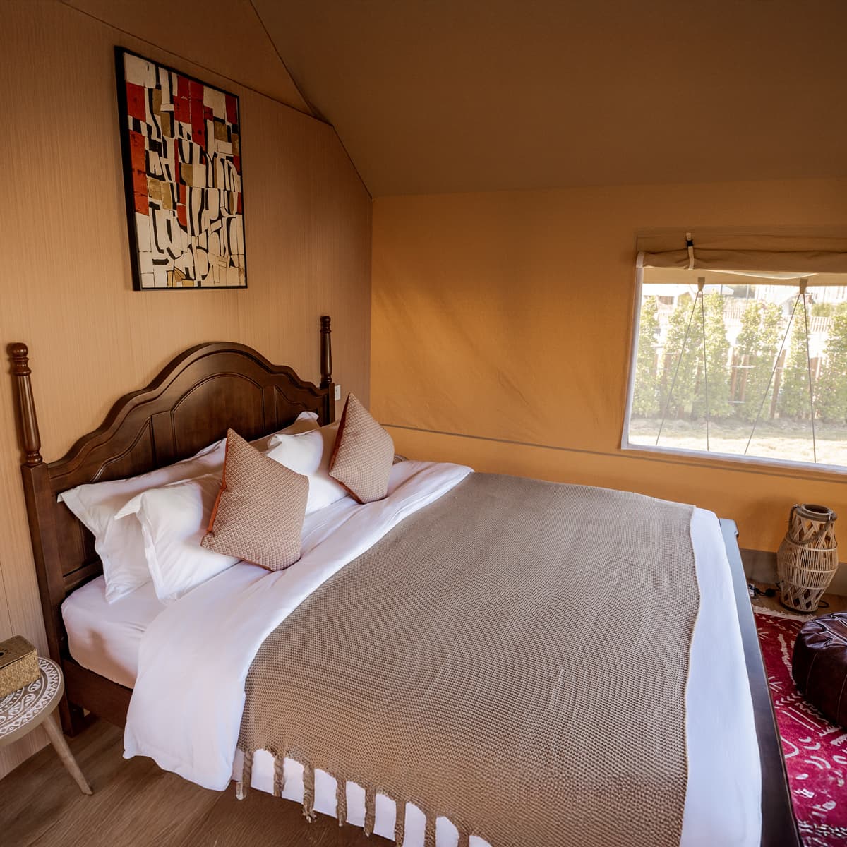 Warmly furnished safari tent bedroom