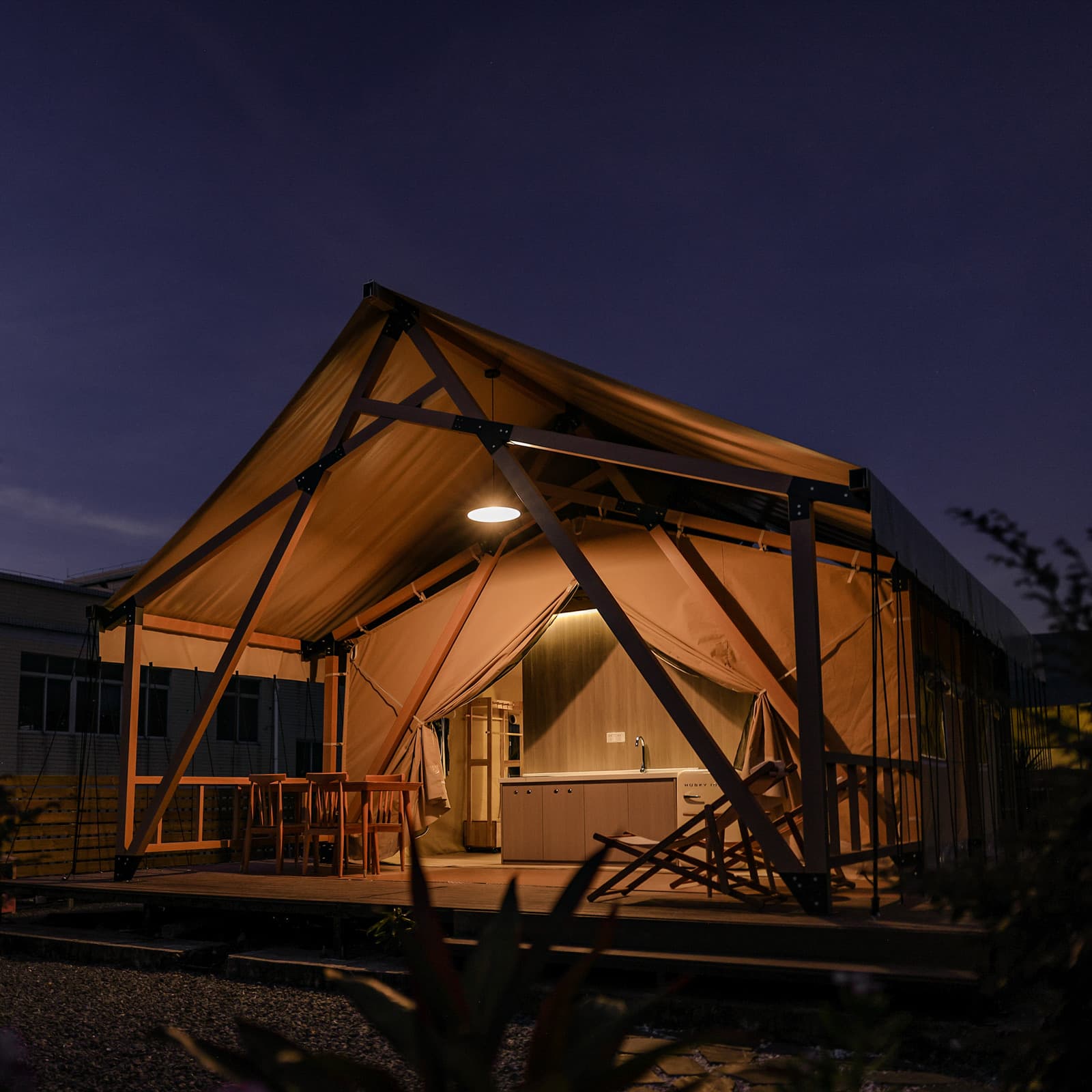 Safari tent illuminated at night